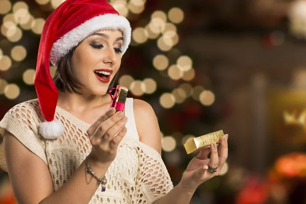 Christmas Gift - woman opening gift surprised and happy