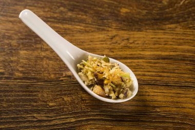 Sahanda yumurta, muz püresi ve gevrek patates bir kaşık rendelenmiş cod.