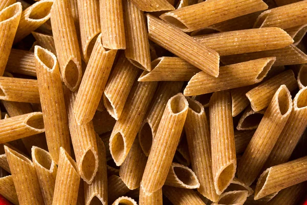 Top view of uncooked pasta integral on a wooden background — Stock Photo, Image