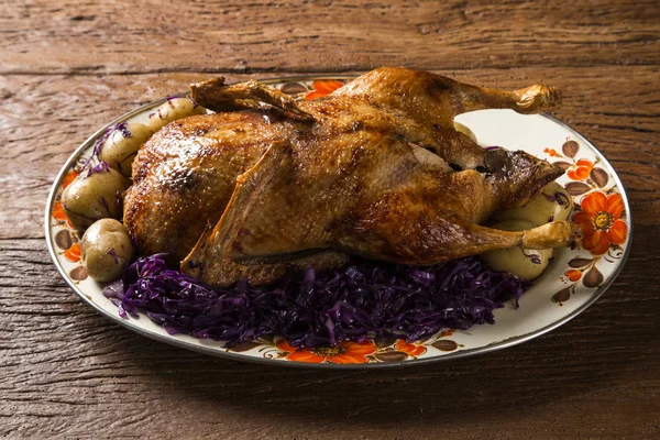 Roast duck with potatoes and purple cabbage
