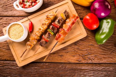 Bir tahta üzerine çeşitli biftek şişleri