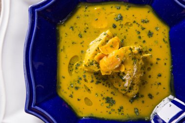 Ahşap bir masa üzerinde tavuk ile Pequi meyve. Frango com pequi.