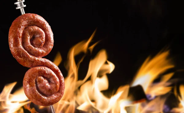 Salsicha no fogo, tradicional churrasco brasileiro . — Fotografia de Stock