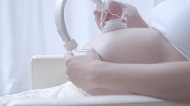 Pregnant Woman Holding Headphones Her Tummy — Stock Video