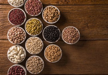 Kase ahşap arka plan üzerinde çeşitli fasulye