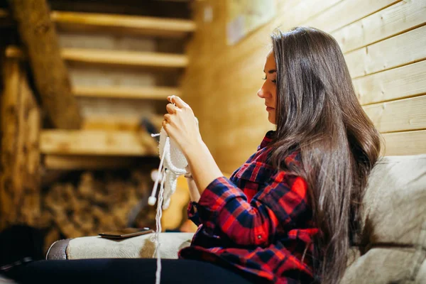 Vrouw breien in houten huis — Stockfoto