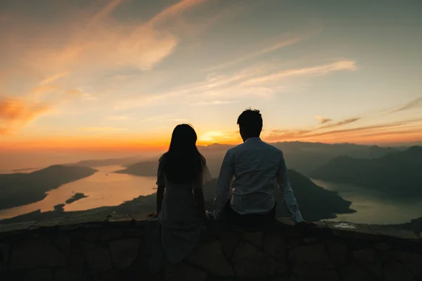 honeymoon couple kiss and embrace at sunset