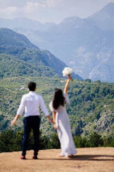 honeymoon wedding couple travel mountains back view