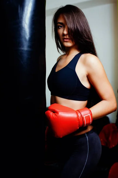 Sexy fighter girl in gym with boxing bag — Stock Photo, Image