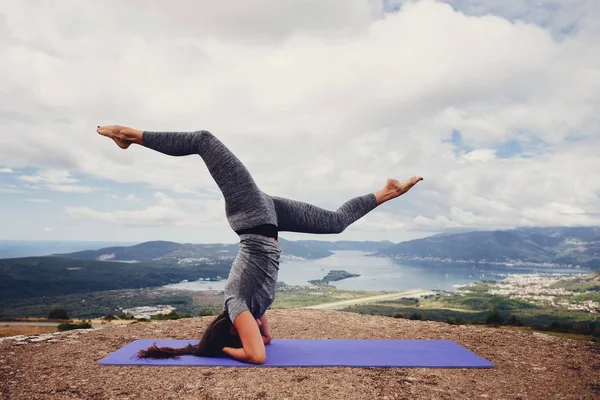 woman practicing yoga in mountains