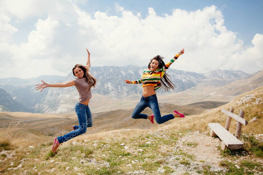 happy women travel and jump together