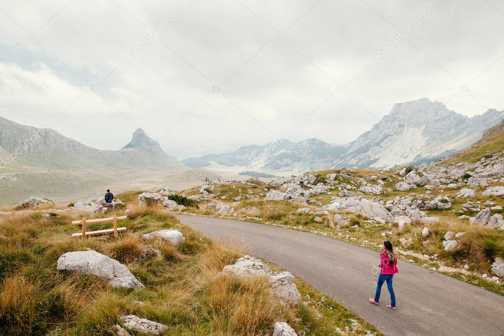 man and woman travel and relax in mountains