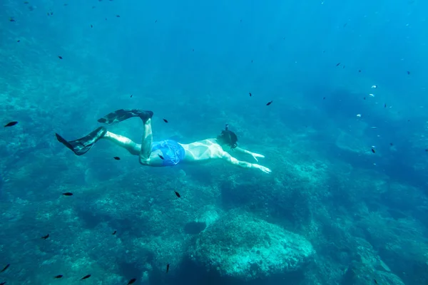 Muž plavat pod vodou v šnorchlu — Stock fotografie