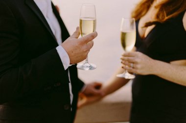 Şampanya günbatımında açık havada içki Çift