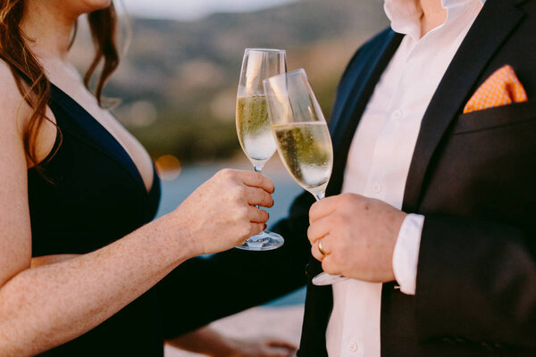 couple drinking champagne at sunset outdoors