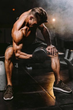 Spor salonundaki vücut geliştiren adam ellerini kaldırıyor. Spor salonundaki vücut geliştirme portresi. Konsantrasyon