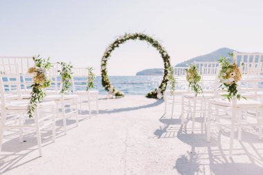 Karadağ 'da deniz manzaralı düğün kemeri resepsiyonu. Deniz ve dağ manzaralı beyaz düğün yeri. Hedef düğün yeri.