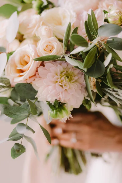 bride holding wedding bouquet in fine art style. Fine art wedding bouquet with peonies. Airy photo