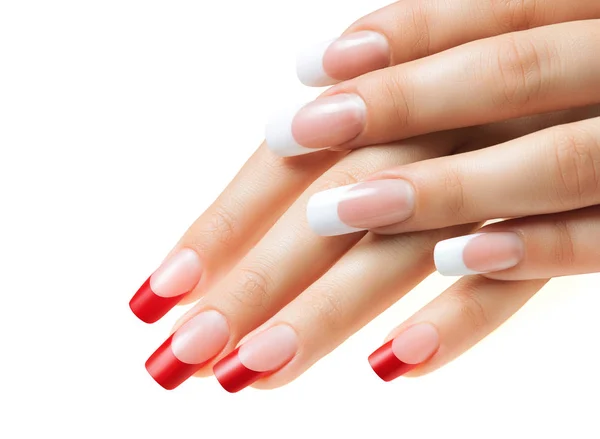 Händerna på flickor. Kvinnliga manikyr. Röda och vita naglar. Stockbild