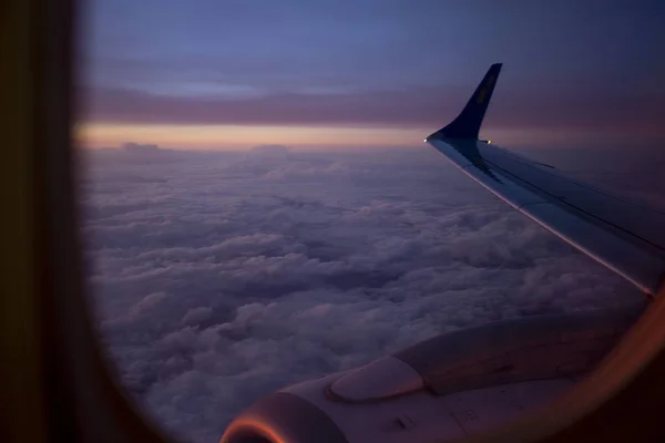 View from the airplane window on pink colorful sunrise