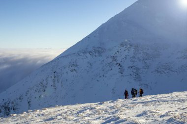 Dört kişilik bir grup dağdan aşağı iniyor.