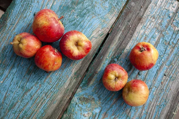 Red apples on a blue old painted board. — 스톡 사진