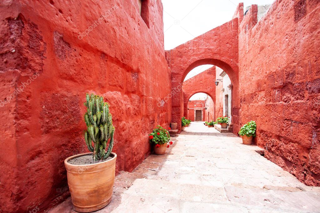 Arches on the streets in the monastery of Santa Catalina, Arequipa, Peru, cacti and geraniums in pots.