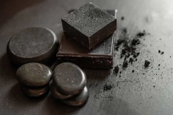 Black carbon charcoal soap on a black granit background