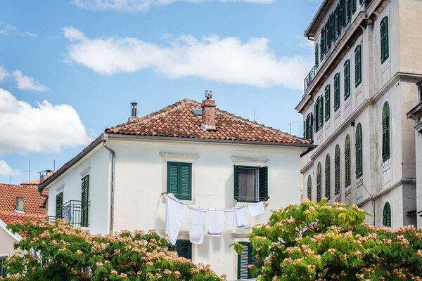 Holiday tourist summer destination split old town croatia house with line dry washing outside green window shutters