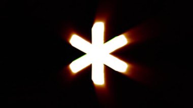 Shiny fire asterisk icon fly in center flickers with rgb spectrum colors.