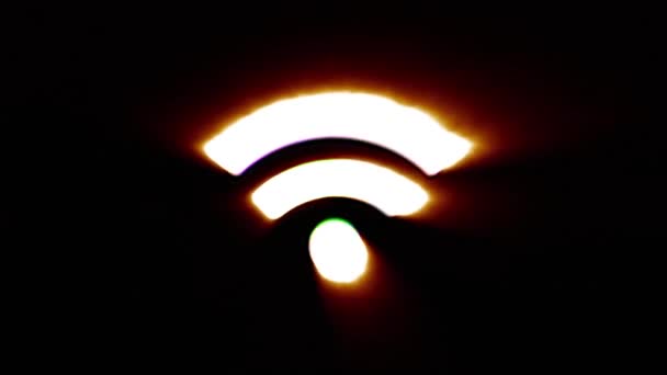 Shiny fire Wi-Fi icon fly in center flickers with rgb spectrum colors. — Stockvideo