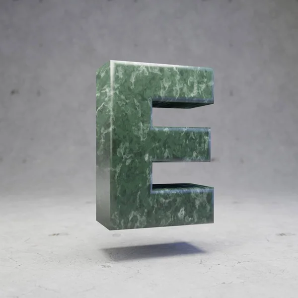 Green marble letter E uppercase on concrete background. 3d rendered glossy stone font character.