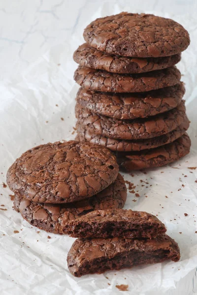 Fudge brownie cookies stack on parchment