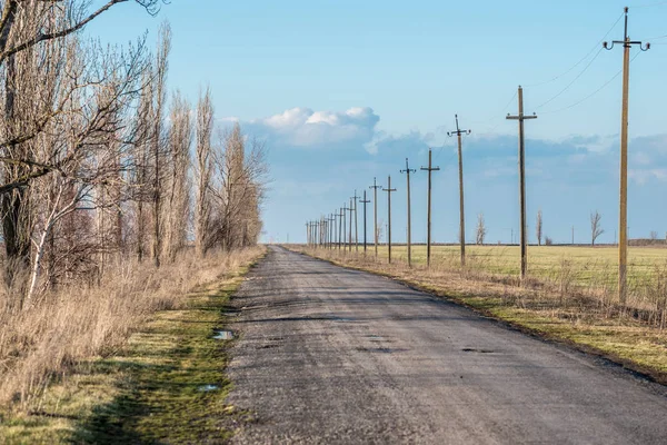 Old road against the sky with clouds — Stock Photo, Image