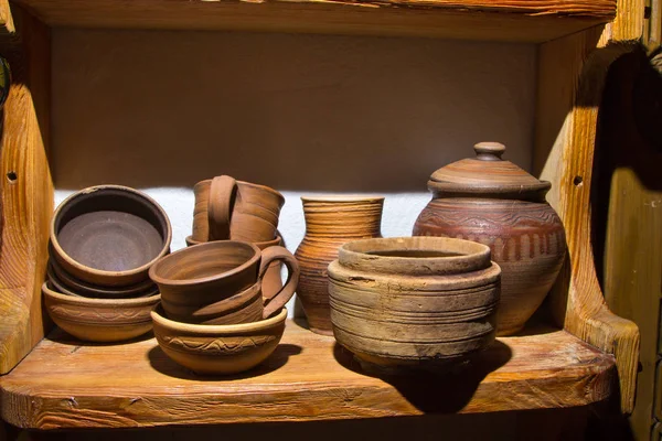 Clay dishes on old wooden background