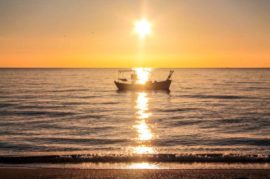 denizin üzerinde yükselen güneş