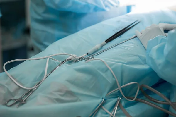 Surgical instruments during cosmetic surgery on breasts