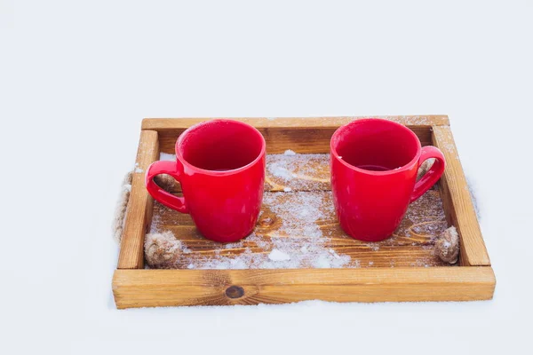 Чашки на підносі в снігу, зимовий пікнік — стокове фото