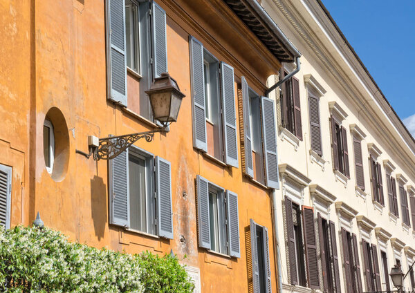 Windows and and street lamp in an alley in Rome Italy