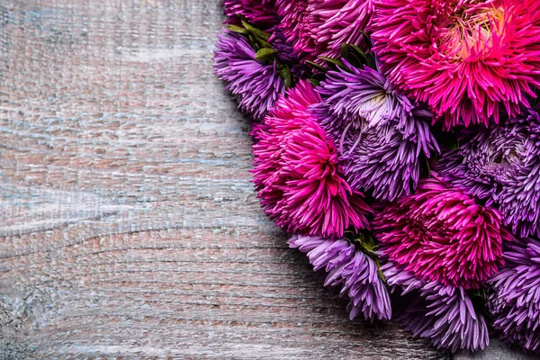 Aster flowers bouquet purple red pink white on a wooden background. selective focus