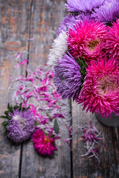 Aster flowers bouquet purple red pink white on a wooden background. selective focus