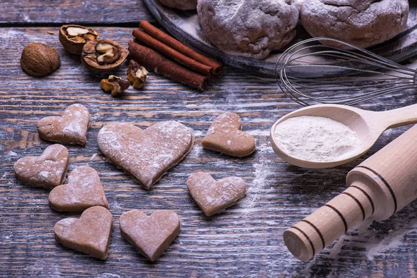 Christmas cookies. Ingredients for baking: dough, flour, forms for biscuits on wooden background