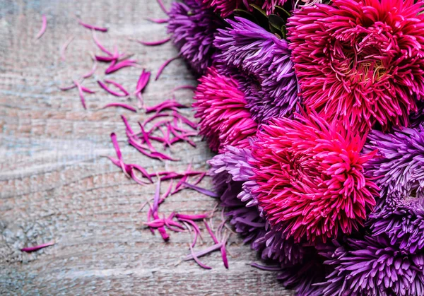 Aster flowers bouquet purple red pink white on a wooden background. selective focus