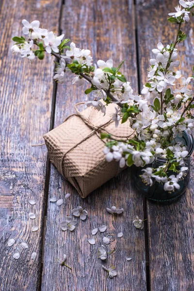 Spring flowers , present box, gift on dark vintage wooden background