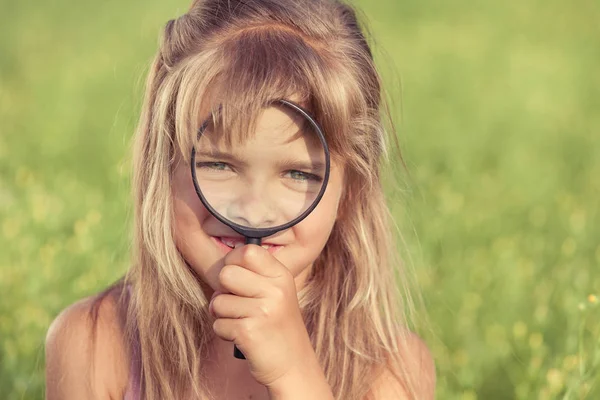 Doğa büyüteç ile keşfetmek mutlu küçük kız 