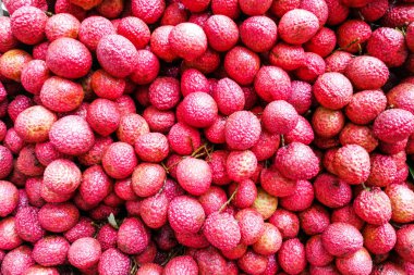 Close-up on heap group of lychee fruits tied together clipart