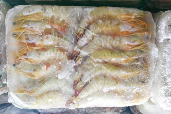 Frozen prawns shrimps in ice bag to preserve freshness