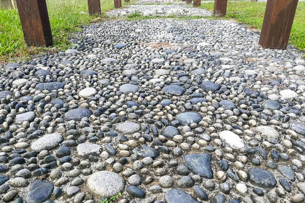 Close-up on pressure points pebble stones at foot reflexology park