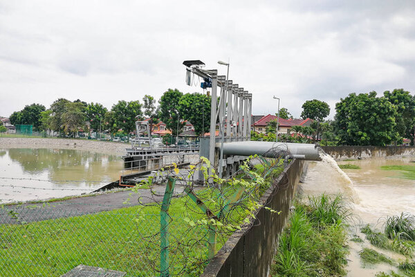 Rain water pumped into river from flood storm retention pond