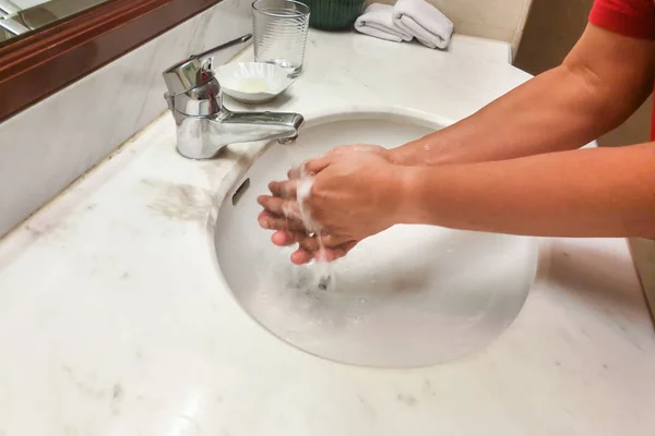 Person washing hands  with running water from tap faucet — Stock Photo, Image